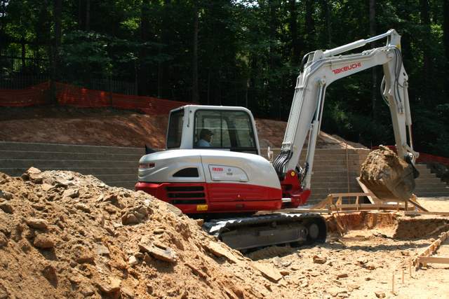 The new Takeuchi TB285 midsize excavator does some pool work. 